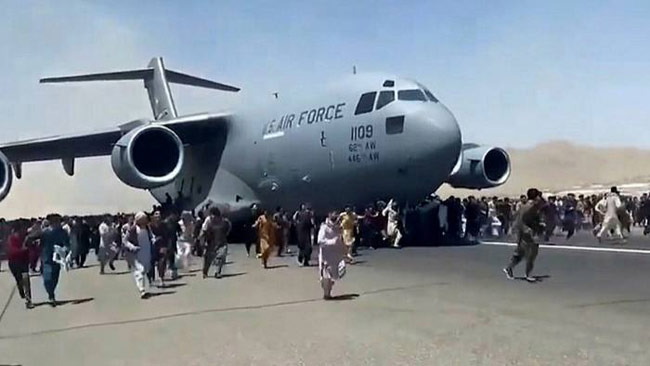 At least five dead as Afghans swarm airport to escape Taliban rule