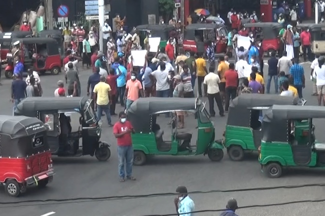 Protesting three-wheeler drivers block Galle Road in Panadura