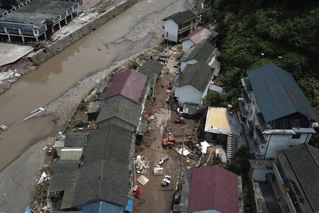 Flooding displaces 10,000 around China as Beijing gets a relative respite from sweltering heat