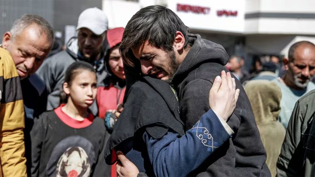 Dozens killed waiting for aid in Gaza, overall death toll passes 30,000