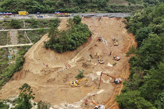 Death toll jumps to at least 48 in southern China highway collapse as search continues