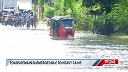 Several areas and roads remain inundated  despite decrease in rainfall across island (English)