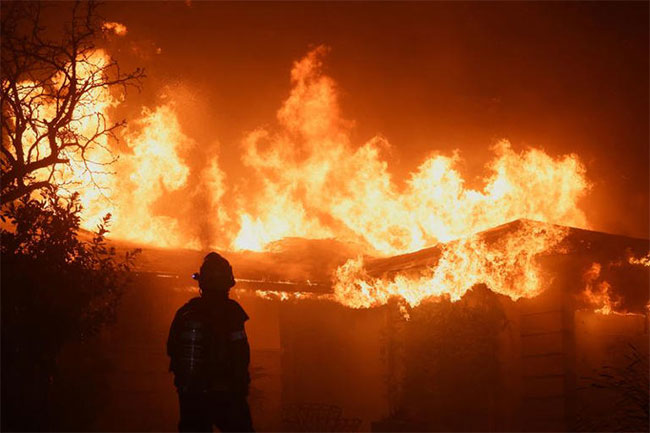 Tens of thousands flee as wildfires tear through Los Angeles area