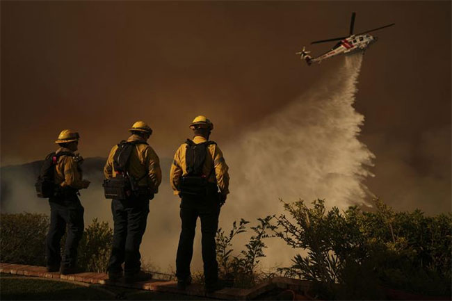 As winds pick up, LA firefighters desperately battle to contain monster inferno