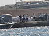 Boat carrying migrants capsizes off Italy, killing at least 26