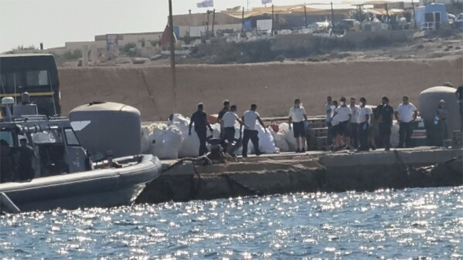 Boat carrying migrants capsizes off Italy, killing at least 26