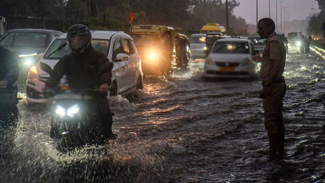 Eight-hour traffic jams in Delhi suburb as rains wreak havoc