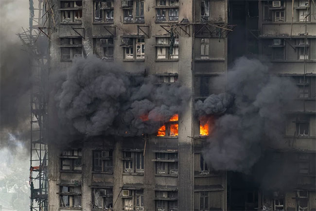 At least 65 dead as Hong Kong firefighters battle burning towers for a second day