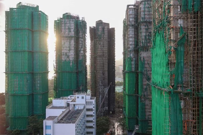 Hong Kong mourns victims of fire that killed 128 and counting