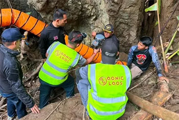 Rescuers race to free seven people trapped in flooded Laos cave